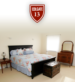 A photo of a bedroom with the Colgate 13 logo